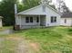 Charming one-story home with a cozy front porch and well-lit front yard at 1146 Buffalo St, Shelby, NC 28150