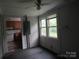 Cozy living room featuring bright windows and a ceiling fan, transitioning into the kitchen at 1146 Buffalo St, Shelby, NC 28150