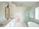 Bathroom featuring double vanity, free standing tub, and a glass enclosed shower at 12520 Vantage Point Ln, Huntersville, NC 28078