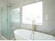 Luxurious bathroom with a soaking tub and a glass enclosed shower at 12520 Vantage Point Ln, Huntersville, NC 28078