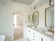 Modern bathroom with marble walls and double vanity with stylish fixtures at 12520 Vantage Point Ln, Huntersville, NC 28078