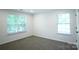 Bedroom with two windows offering natural light and neutral-toned carpet at 12520 Vantage Point Ln, Huntersville, NC 28078