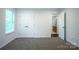 Bedroom with large window, gray carpet, and double doors to the closet at 12520 Vantage Point Ln, Huntersville, NC 28078