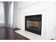 Close up of a fireplace featuring a stone hearth with a white mantle and dark hardwood floors at 12520 Vantage Point Ln, Huntersville, NC 28078