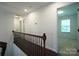Upstairs hallway with wood floors and decorative wrought iron spindles at 12520 Vantage Point Ln, Huntersville, NC 28078