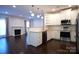 Beautiful kitchen with white cabinets, modern appliances, and open layout to living room at 12520 Vantage Point Ln, Huntersville, NC 28078