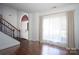 Bright living room featuring gleaming wood floors and abundant natural light through large windows at 12520 Vantage Point Ln, Huntersville, NC 28078