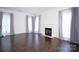 Spacious living room featuring hardwood floors, a cozy fireplace, and lots of natural light at 12520 Vantage Point Ln, Huntersville, NC 28078