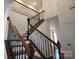 Ornate staircase with wooden railings, iron spindles, and carpeted steps at 12520 Vantage Point Ln, Huntersville, NC 28078