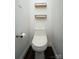 Powder room featuring a modern toilet and floating shelves at 12520 Vantage Point Ln, Huntersville, NC 28078