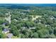 Aerial view of estate home with lake views nestled among verdant trees in a residential neighborhood at 1503 Jack White Dr, Rock Hill, SC 29732