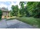 Well-manicured backyard with a concrete patio and mature trees at 1503 Jack White Dr, Rock Hill, SC 29732