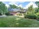 Expansive backyard featuring lush green grass, screened-in porch, and mature landscaping at 1503 Jack White Dr, Rock Hill, SC 29732