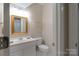 Powder room featuring updated vanity, neutral walls, attractive mirror and a white ceramic toilet at 1503 Jack White Dr, Rock Hill, SC 29732