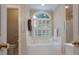 Bathroom features a soaking tub, white tile, and a window with decorative shutters at 1503 Jack White Dr, Rock Hill, SC 29732