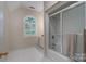 Bathroom with white ceramic tile floor, walk in shower, window, updated vanity and natural light at 1503 Jack White Dr, Rock Hill, SC 29732