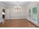 Spacious dining room with hardwood floors, elegant chandelier, large window, and neutral paint at 1503 Jack White Dr, Rock Hill, SC 29732