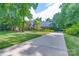 Charming brick home with lush landscaping, mature trees, and a long driveway at 1503 Jack White Dr, Rock Hill, SC 29732