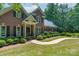 Charming brick home featuring a classic design, well-manicured lawn and dark shutters at 1503 Jack White Dr, Rock Hill, SC 29732
