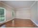 Bright, neutral living room featuring hardwood floors, white trim, and large windows for natural light at 1503 Jack White Dr, Rock Hill, SC 29732