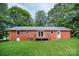 Red brick home features a cozy wooden deck and spacious, green backyard at 1538 Hilltop Dr, Shelby, NC 28150