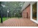 A modern deck is attached to a red brick house perfect for outdoor entertainment and relaxation at 1538 Hilltop Dr, Shelby, NC 28150