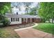Beautiful red brick home with a walkway and lush landscaping creates great curb appeal at 1538 Hilltop Dr, Shelby, NC 28150