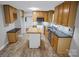 Well-lit kitchen featuring custom cabinetry, a functional island, and stylish backsplash at 1538 Hilltop Dr, Shelby, NC 28150