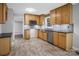 Well-lit kitchen featuring oak cabinets, stainless steel appliances, and tiled flooring at 1538 Hilltop Dr, Shelby, NC 28150
