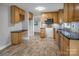 Well-lit kitchen with oak cabinets, stainless steel appliances, and tile floors at 1538 Hilltop Dr, Shelby, NC 28150