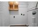 Compact laundry area with built-in storage shelves at 1538 Hilltop Dr, Shelby, NC 28150