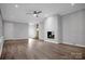 Spacious living room featuring white brick fireplace and vinyl flooring at 1538 Hilltop Dr, Shelby, NC 28150