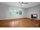 Bright living room with hardwood floors, large windows, ceiling fan, and fireplace at 1538 Hilltop Dr, Shelby, NC 28150