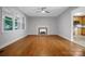 Bright living room with hardwood floors, fireplace, and open doorway to kitchen at 1538 Hilltop Dr, Shelby, NC 28150