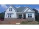 Beautiful new construction home with brick base, white siding, and covered front porch at 156 Triple Ponds Ct, Clover, SC 29710