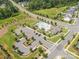A beautiful aerial view showcases a community pool, clubhouse, and parking area amidst lush landscaping at 19012 Beecher Commons Dr, Huntersville, NC 28078