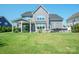 Spacious backyard with a well-maintained lawn, patio, and outdoor seating, perfect for relaxing and entertaining at 19012 Beecher Commons Dr, Huntersville, NC 28078