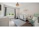 Bright Bedroom featuring a crib, accent rug, teepee and light-green painted rocking chair at 19012 Beecher Commons Dr, Huntersville, NC 28078