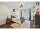 Well-lit bedroom with hardwood floors, a plush rug, and tasteful decor, creating a cozy atmosphere at 19012 Beecher Commons Dr, Huntersville, NC 28078