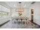 Elegant dining room with a modern chandelier and plenty of seating for guests at 19012 Beecher Commons Dr, Huntersville, NC 28078