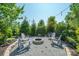 Inviting backyard fire pit area with Adirondack chairs and string lights, perfect for outdoor entertaining at 19012 Beecher Commons Dr, Huntersville, NC 28078