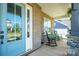 Charming front porch with rocking chairs, perfect for relaxing and enjoying the outdoors at 19012 Beecher Commons Dr, Huntersville, NC 28078