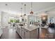 Bright, open-concept kitchen with large island flows into dining and living areas with ample natural light at 19012 Beecher Commons Dr, Huntersville, NC 28078
