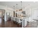 Bright kitchen featuring a large island with seating, stainless steel appliances, and stylish pendant lighting at 19012 Beecher Commons Dr, Huntersville, NC 28078