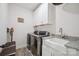 Efficient laundry room with modern appliances, ample storage, and a convenient sink for added functionality at 19012 Beecher Commons Dr, Huntersville, NC 28078