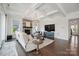 Inviting living room with coffered ceiling, stone fireplace, and large TV for cozy entertaining at 19012 Beecher Commons Dr, Huntersville, NC 28078