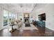 Spacious living room with coffered ceiling, stone fireplace, and large windows showcasing the backyard at 19012 Beecher Commons Dr, Huntersville, NC 28078