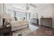 Comfortable main bedroom with hardwood floors, tray ceiling, and large windows at 19012 Beecher Commons Dr, Huntersville, NC 28078