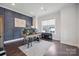 Stylish home office featuring a decorative accent wall and ample natural light at 19012 Beecher Commons Dr, Huntersville, NC 28078