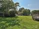 Large backyard with mature trees and lawn area at 2912 Peachwood Ct, Fort Mill, SC 29715